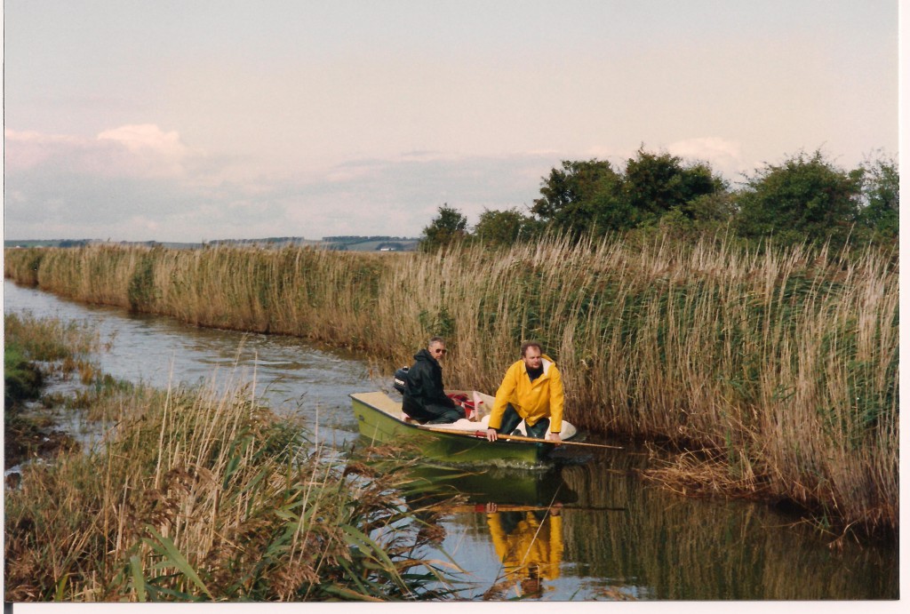 Erik Jeppesen in front and a technician in action in the large  shallow brackish lake  system Vejlerne , Denmark